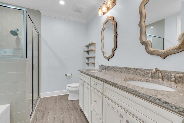 765 Lagoon Dr, North Palm Beach, FL 33408 - bathroom featuring toilet, a stall shower, wood finished floors, baseboards, and ornamental molding