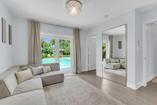 765 Lagoon Dr, North Palm Beach, FL 33408 - living area featuring healthy amount of natural light, wood finished floors, and baseboards