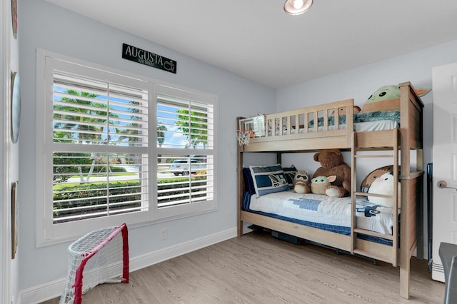 765 Lagoon Dr, North Palm Beach, FL 33408 - bedroom with wood finished floors and baseboards