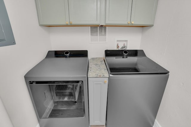 765 Lagoon Dr, North Palm Beach, FL 33408 - clothes washing area with washer and dryer and cabinet space