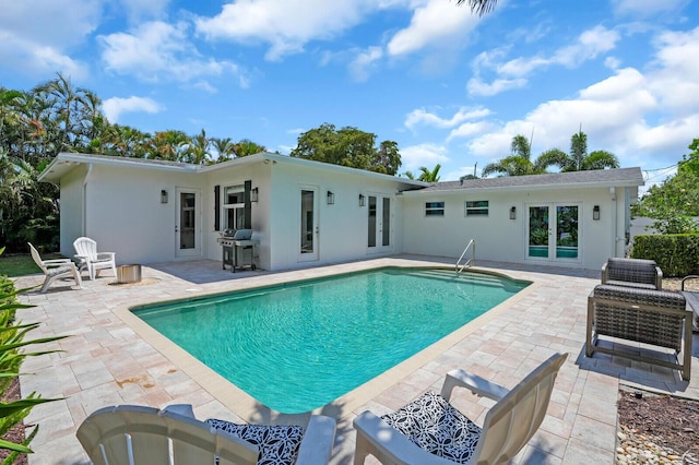 765 Lagoon Dr, North Palm Beach, FL 33408 - outdoor pool featuring a patio area, french doors, and grilling area