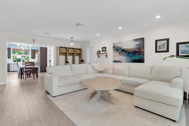 765 Lagoon Dr, North Palm Beach, FL 33408 - living room with light wood-style floors, crown molding, recessed lighting, and a chandelier