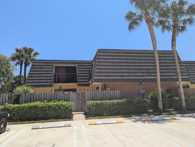 4703 47th Way, West Palm Beach, FL 33407 - view of building exterior featuring fence and uncovered parking