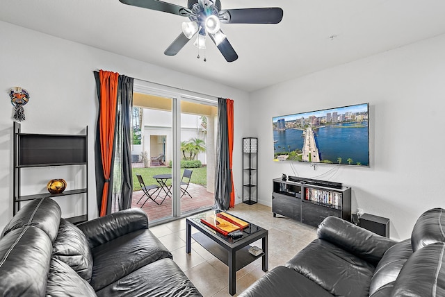 living area featuring ceiling fan, light tile patterned flooring, and baseboards