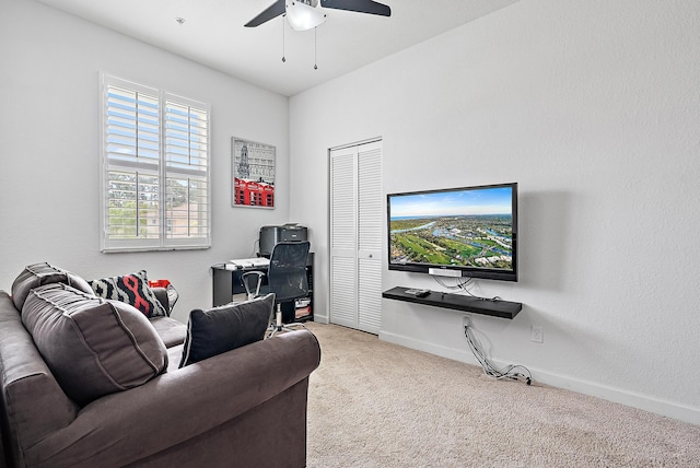 living room with ceiling fan, carpet, and baseboards