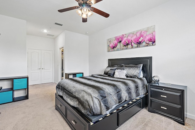 bedroom with light carpet, a closet, baseboards, and ceiling fan