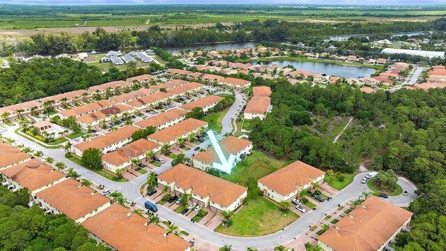 aerial view of property's location featuring a nearby body of water and nearby suburban area