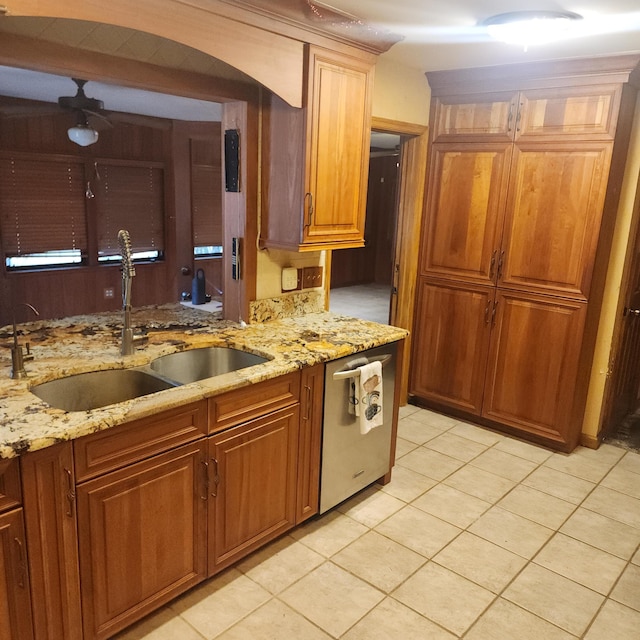 16761 130th Way N, Jupiter, FL 33478 - kitchen with dishwasher, ceiling fan, light stone countertops, light tile patterned flooring, and brown cabinets