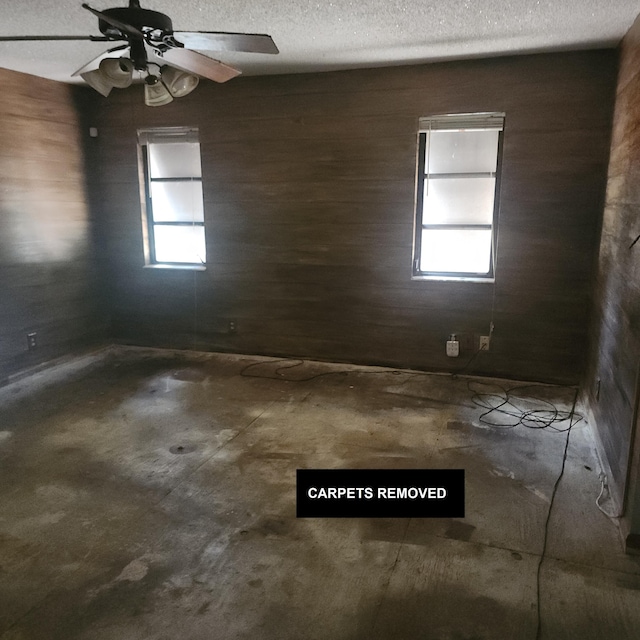 16761 130th Way N, Jupiter, FL 33478 - spare room featuring unfinished concrete floors, a textured ceiling, and a ceiling fan