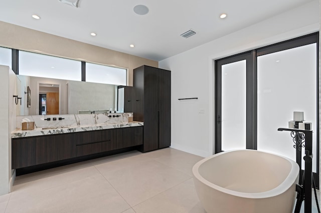 160 Periwinkle Dr, Hypoluxo, FL 33462 - full bathroom featuring a freestanding bath, vanity, tile patterned floors, recessed lighting, and baseboards