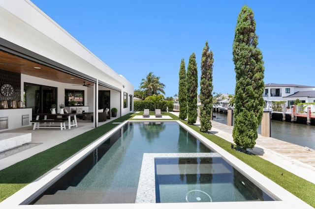 160 Periwinkle Dr, Hypoluxo, FL 33462 - view of pool featuring a patio, outdoor lounge area, a ceiling fan, a pool with connected hot tub, and a water view