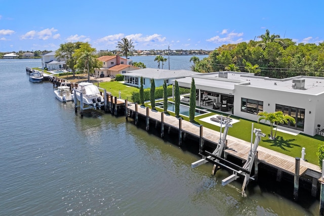 160 Periwinkle Dr, Hypoluxo, FL 33462 - dock area with boat lift, a water view, a lawn, and a patio area