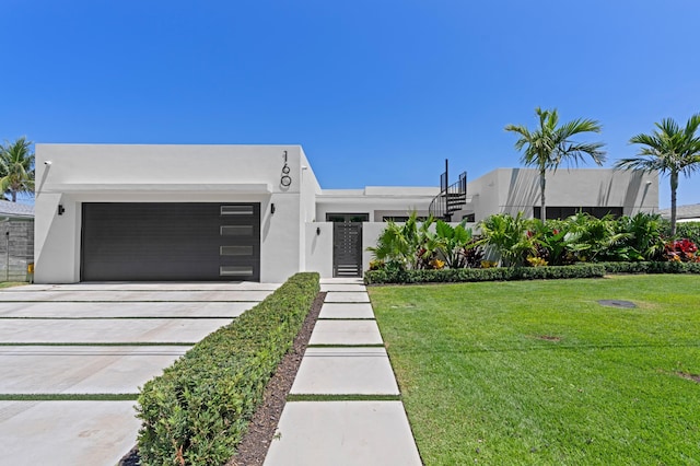 160 Periwinkle Dr, Hypoluxo, FL 33462 - view of front facade with an attached garage, driveway, stucco siding, and a front yard