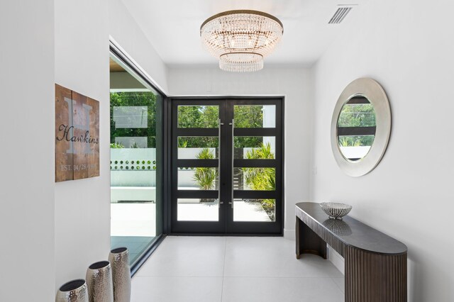 160 Periwinkle Dr, Hypoluxo, FL 33462 - entryway with french doors, tile patterned flooring, and a chandelier