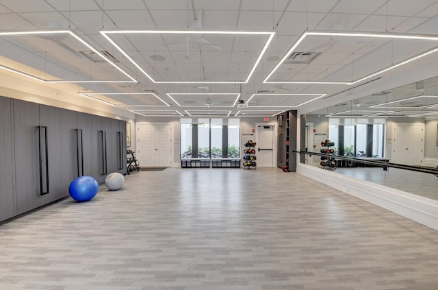 exercise room featuring light wood-style floors and baseboards