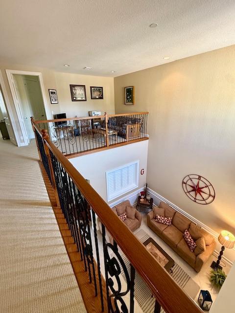 stairway with a textured ceiling