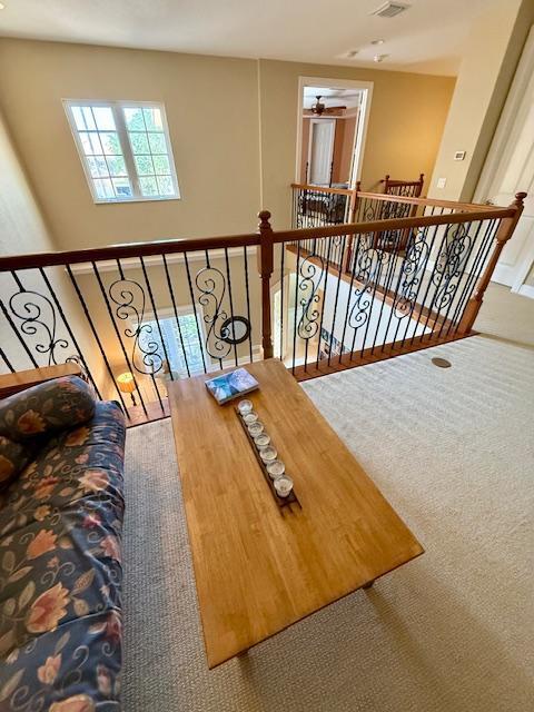 interior space with ceiling fan and carpet floors