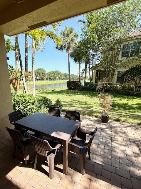 view of patio / terrace featuring a water view and outdoor dining space