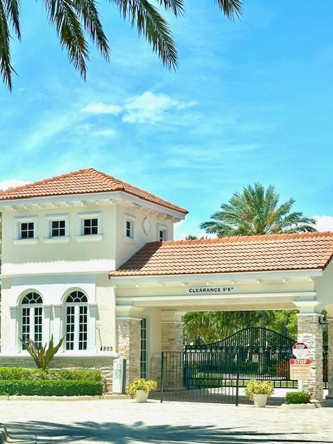 view of building exterior with fence and concrete driveway