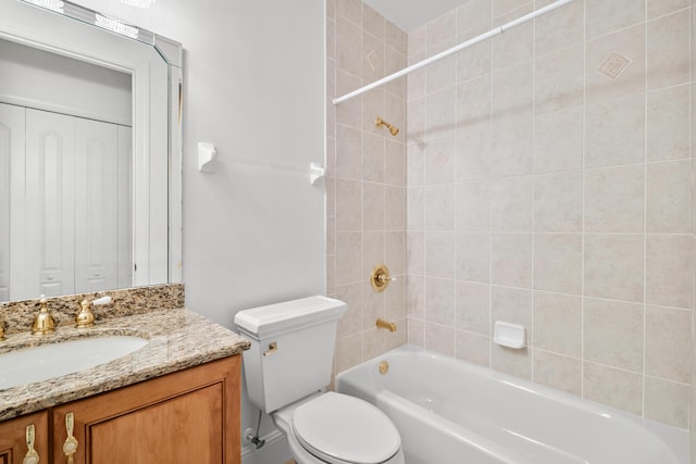 bathroom featuring shower / bath combination, vanity, and toilet