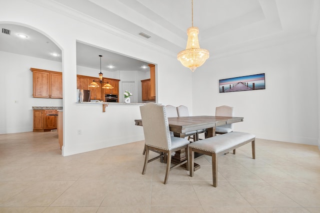 dining area with light tile patterned floors, recessed lighting, arched walkways, and baseboards