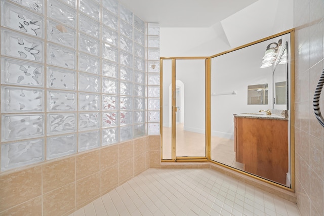 bathroom featuring a shower stall, tile patterned floors, and vanity