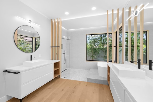 17726 Litten Dr, Boca Raton, FL 33498 - bathroom with walk in shower, wood finished floors, a freestanding bath, vanity, and recessed lighting
