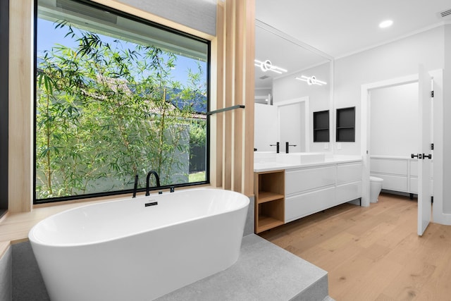 17726 Litten Dr, Boca Raton, FL 33498 - full bathroom featuring wood finished floors, vanity, toilet, a freestanding tub, and recessed lighting