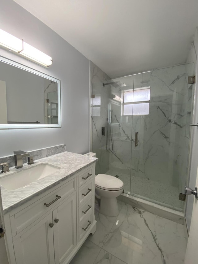 full bathroom featuring a marble finish shower, toilet, vanity, and marble look tile flooring