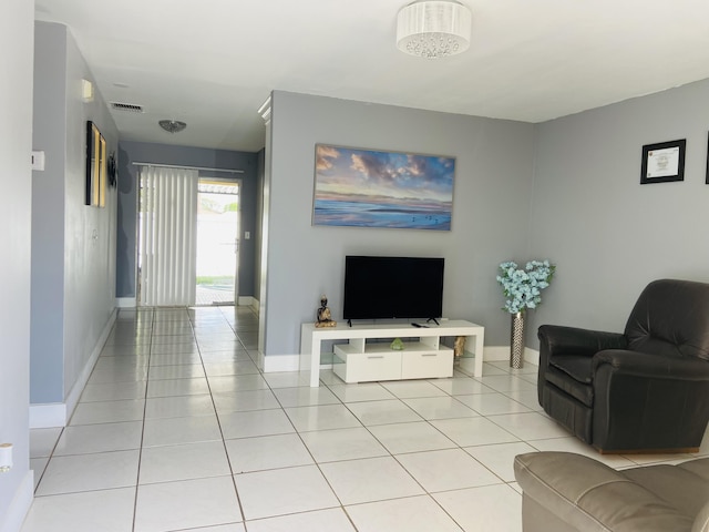 living area featuring light tile patterned floors and baseboards