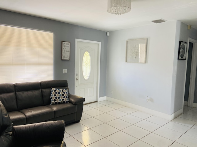 living area featuring light tile patterned flooring and baseboards