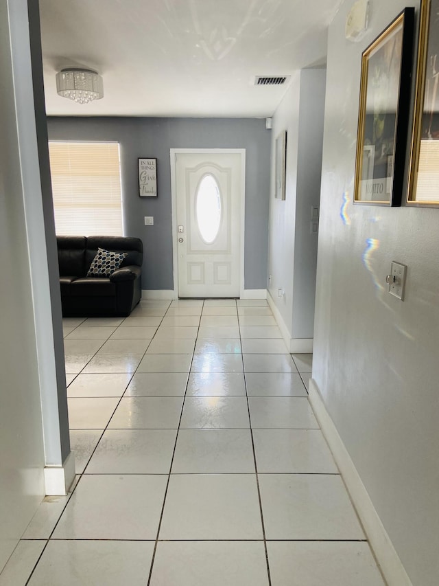 foyer entrance with tile patterned flooring and baseboards