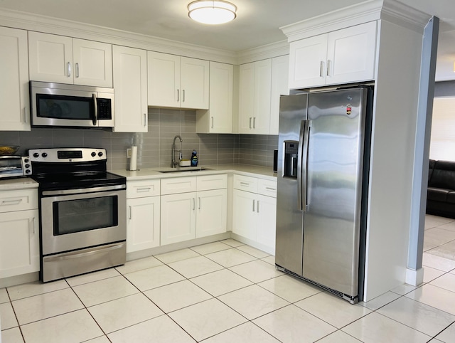 kitchen featuring stainless steel appliances, a sink, backsplash, light countertops, and crown molding
