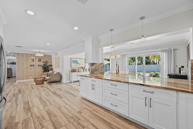 1096 SW 16th St, Boca Raton, FL 33486 - kitchen with open floor plan, crown molding, white cabinets, light stone countertops, and hanging light fixtures