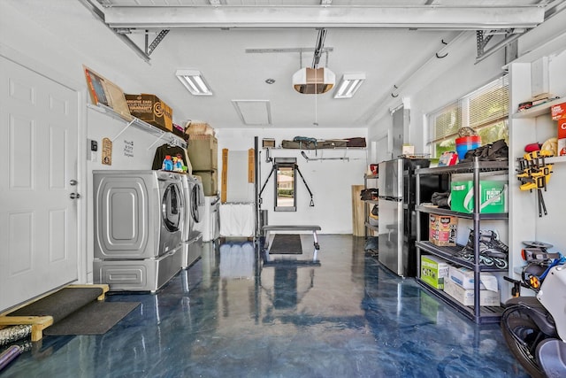 1096 SW 16th St, Boca Raton, FL 33486 - garage featuring washing machine and clothes dryer, freestanding refrigerator, and a garage door opener