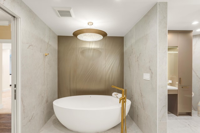 400 S Ocean Blvd Unit R25, Boca Raton, FL 33432 - bathroom featuring tile walls, a freestanding tub, vanity, marble finish floors, and a shower