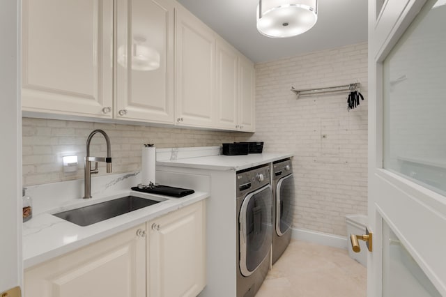 400 S Ocean Blvd Unit R25, Boca Raton, FL 33432 - laundry room featuring cabinet space, washing machine and clothes dryer, brick wall, and light tile patterned floors