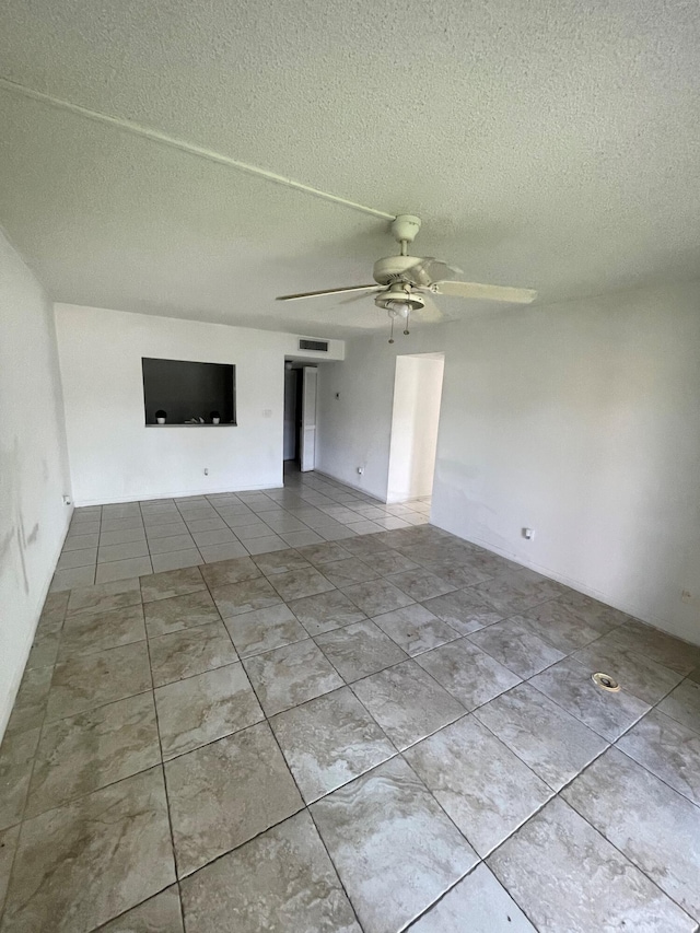 4269 NW 89th Ave Unit 106, Coral Springs, FL 33065 - unfurnished living room featuring tile patterned floors, a ceiling fan, and a textured ceiling