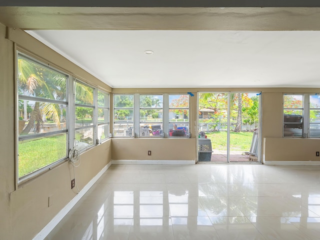 1421 E River Dr, Margate, FL 33063 - unfurnished sunroom with baseboards and tile patterned flooring