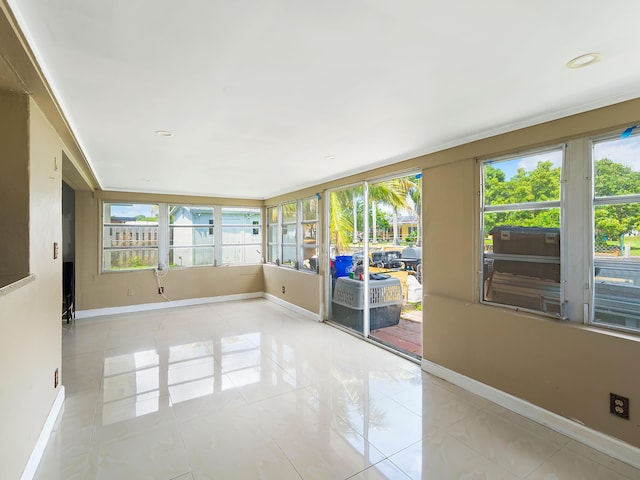 1421 E River Dr, Margate, FL 33063 - unfurnished sunroom featuring baseboards, plenty of natural light, and tile patterned flooring