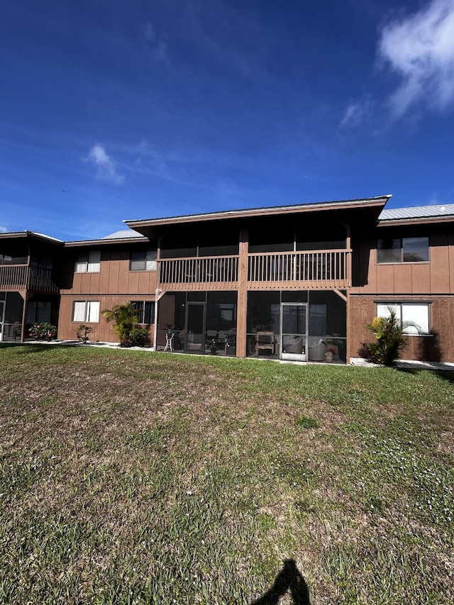 500 N Francisco St Unit 211, Clewiston, FL 33440 - back of property featuring a lawn and metal roof