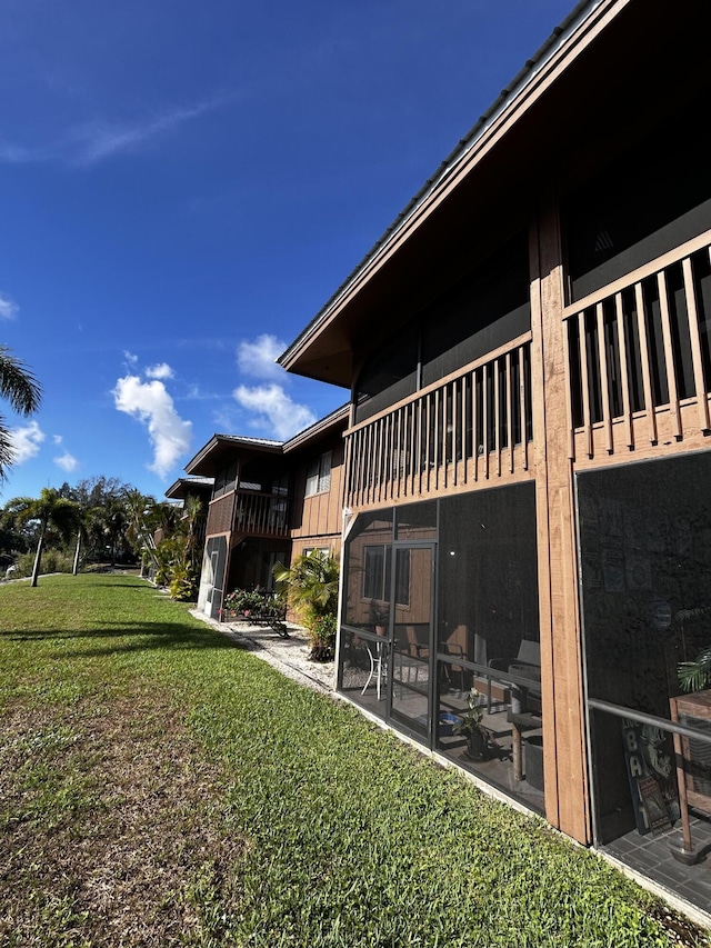 500 N Francisco St Unit 211, Clewiston, FL 33440 - back of house featuring a lawn and a balcony
