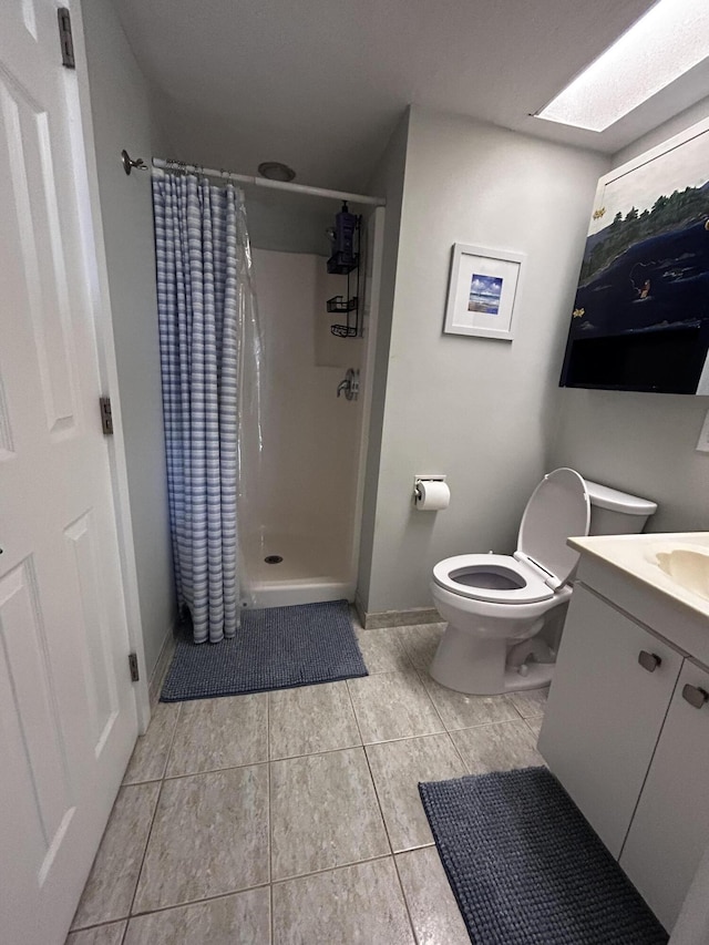 500 N Francisco St Unit 211, Clewiston, FL 33440 - bathroom with a stall shower, toilet, tile patterned flooring, vanity, and baseboards