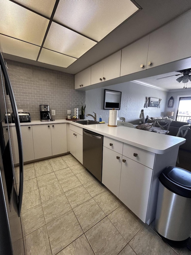 500 N Francisco St Unit 211, Clewiston, FL 33440 - kitchen featuring stainless steel dishwasher, a peninsula, a sink, open floor plan, and light countertops