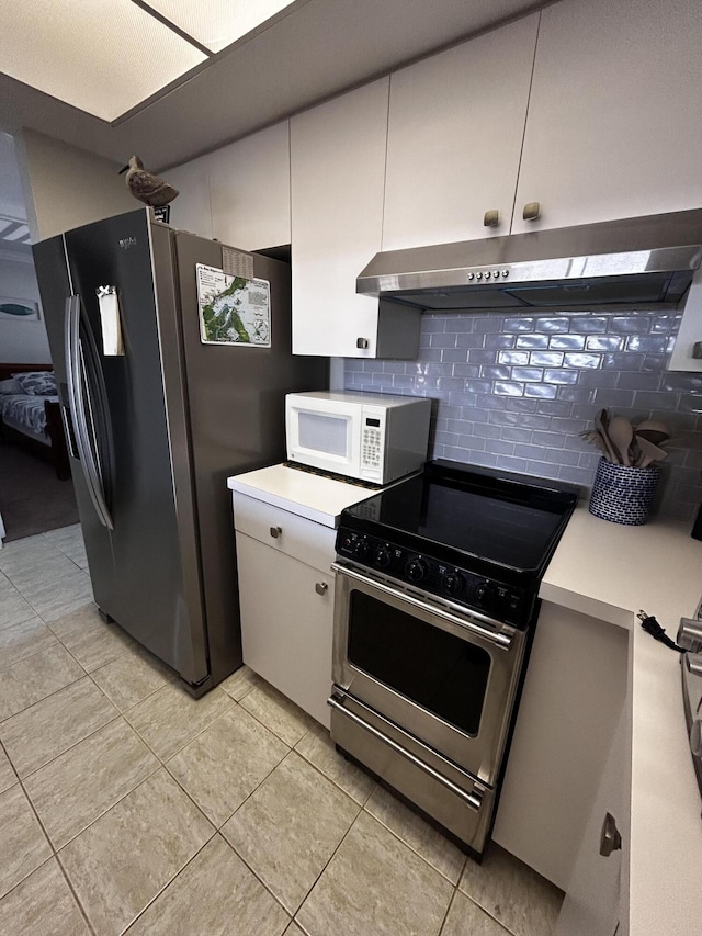 500 N Francisco St Unit 211, Clewiston, FL 33440 - kitchen featuring appliances with stainless steel finishes, extractor fan, backsplash, light countertops, and light tile patterned floors