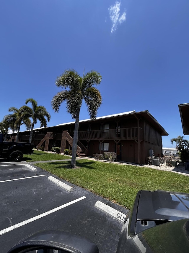 500 N Francisco St Unit 211, Clewiston, FL 33440 - view of property featuring uncovered parking and stairs