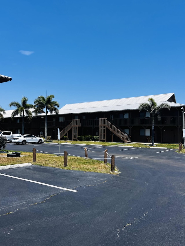 500 N Francisco St Unit 211, Clewiston, FL 33440 - uncovered parking lot with stairs