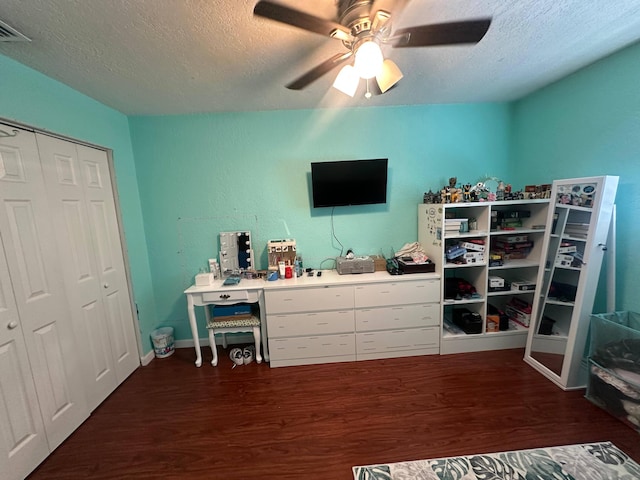 442 Griswold Dr, Lake Worth Beach, FL 33461 - bedroom with dark wood-style flooring, a textured ceiling, a closet, ceiling fan, and baseboards