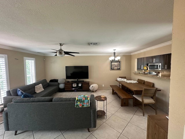 442 Griswold Dr, Lake Worth Beach, FL 33461 - living room featuring ornamental molding, a chandelier, light tile patterned floors, a textured ceiling, and a ceiling fan