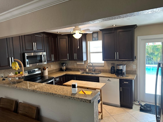 442 Griswold Dr, Lake Worth Beach, FL 33461 - kitchen featuring stainless steel appliances, a sink, tasteful backsplash, and plenty of natural light